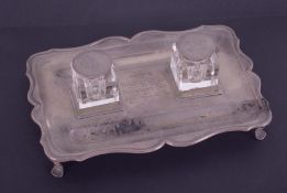 A Geo V silver inkwell stand fitted with two glass inkwells, with inscription 'Presented to Miss