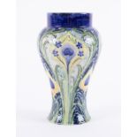 A William Moorcroft Florian Ware vase, with Peacock design, circa 1900, height 24cm.