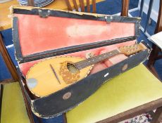 A vintage Mandolin in case (distressed).