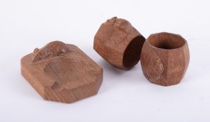 Mouseman, a pair of carved wood napkin rings and an ashtray (3).