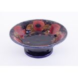 A William Moorcroft footed bowl, decorated with 'Pomegranate', diameter 26cm.