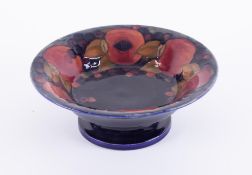 A William Moorcroft footed bowl, decorated with 'Pomegranate', diameter 26cm.