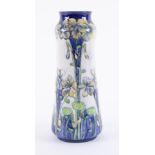 A William Moorcroft Florian Ware vase, with 'Violet' design, circa 1898-1900, height 30cm.