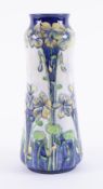 A William Moorcroft Florian Ware vase, with 'Violet' design, circa 1898-1900, height 30cm.