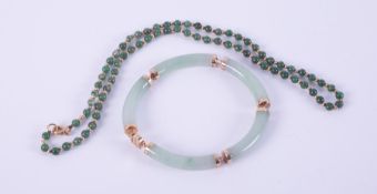 A 9ct yellow gold link bracelet with curved jade sections, length approx. 20cm, 22.41gm and a 9ct