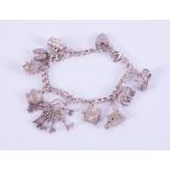 A silver heart padlock charm bracelet with nine silver charms attached including a hedgehog,