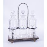 A silver plated three bottle tantalus with a swing top carrying handle.