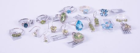 A mixed silver & silver gold overlay jewellery lot to include five blue topaz set rings & a blue