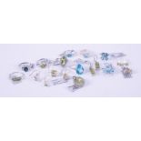 A mixed silver & silver gold overlay jewellery lot to include five blue topaz set rings & a blue