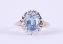 A 9ct yellow & white gold cluster ring set with a central oval cut blue topaz, approx. 2,65