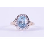 A 9ct yellow & white gold cluster ring set with a central oval cut blue topaz, approx. 2,65