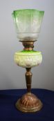 A Victorian oil lamp with green glass column and a green glass shade on a brass base, height 60cm.