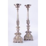 A pair of white metal 'ecclesiastical' candlesticks, height 60cm.