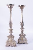 A pair of white metal 'ecclesiastical' candlesticks, height 60cm.