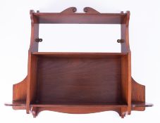 A mahogany hanging wall shelf.