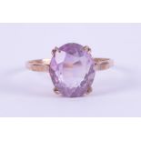 A 9ct yellow gold ring set with an oval amethyst, approx. 4.75 carats, 2.76gm, size T.