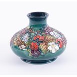 A Moorcroft squat vase, decorated with spring flowers, 15cm wide, height 11cm, boxed.