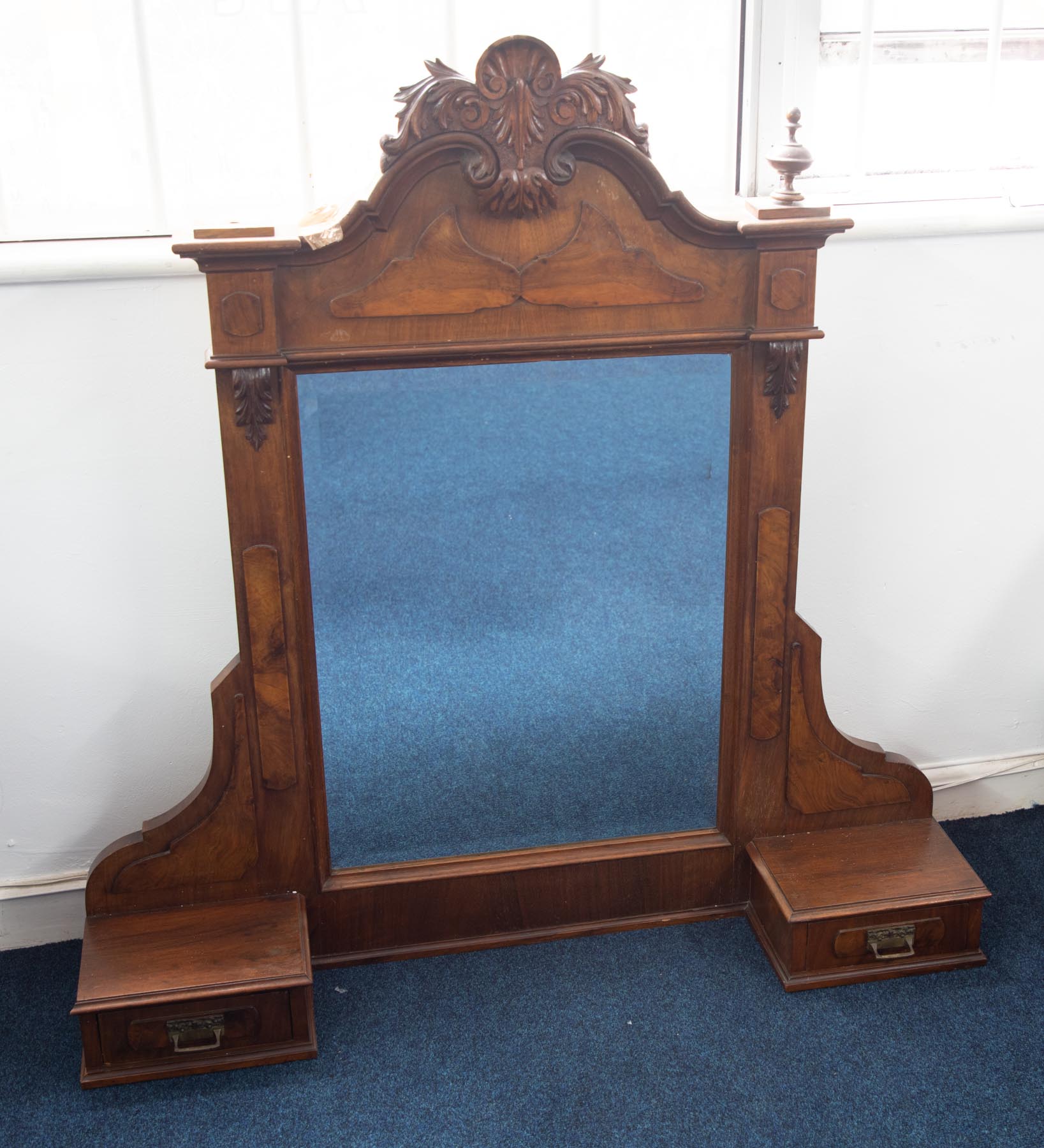 A large late Victorian carved walnut mirror fitted with two drawers, height 119cm.