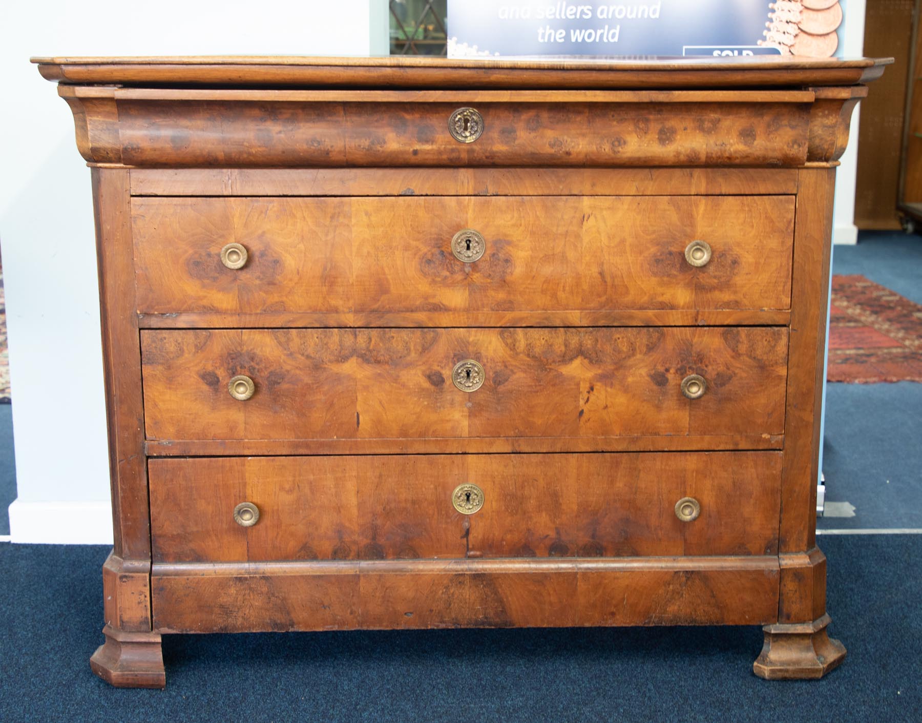 A 19th century figured walnut chest of drawers fitted with four drawers, height 97cm, width 124cm.