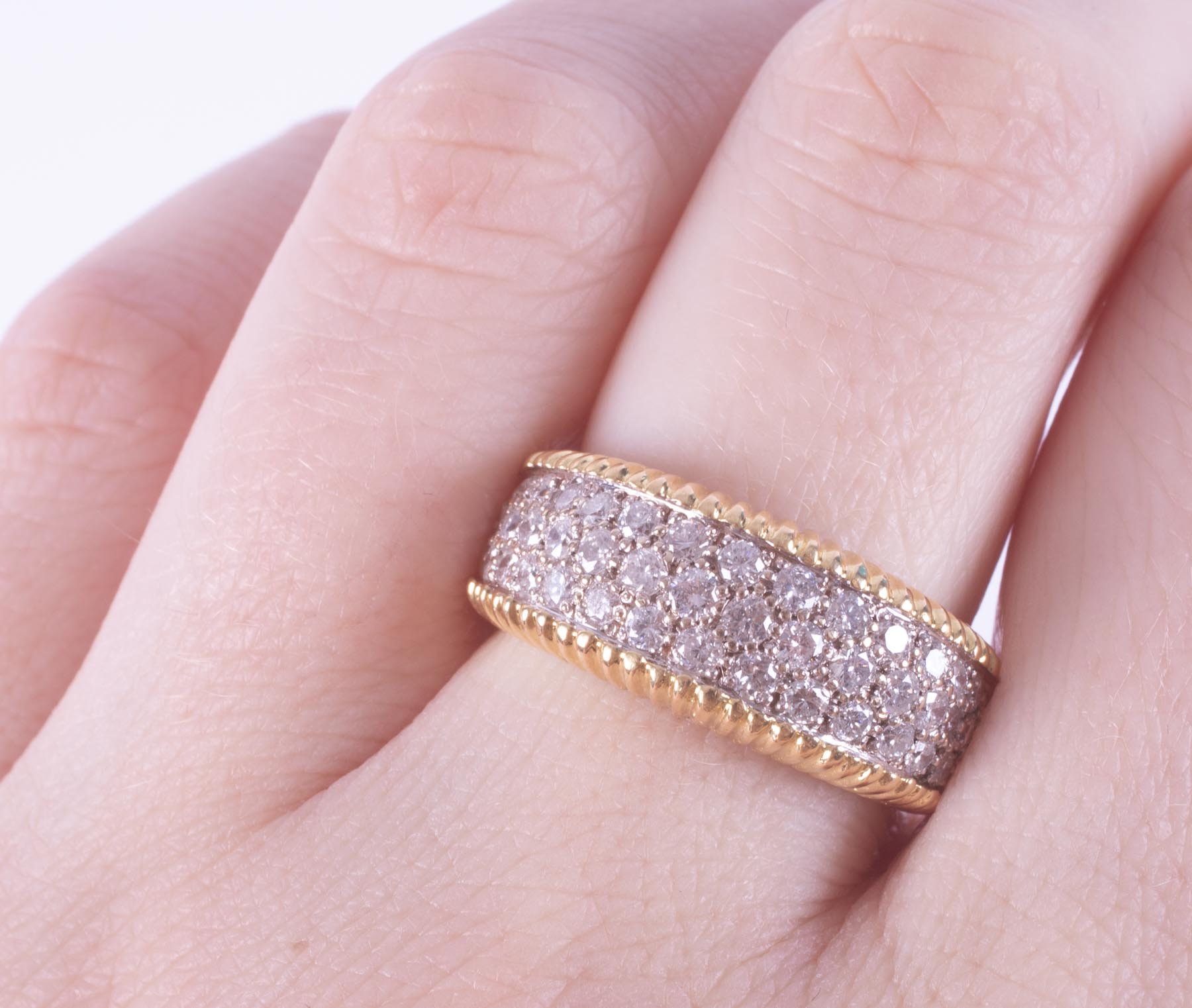 An 18ct yellow & white gold wide band style ring with lined edges and set with three rows of round - Image 2 of 2