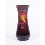 A William Moorcroft shouldered vase, decorated with leaf and berries, height 24cm.