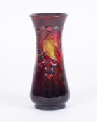 A William Moorcroft shouldered vase, decorated with leaf and berries, height 24cm.