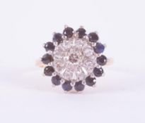 An 18ct yellow & white gold cluster ring set with small round brilliant cut diamonds surrounded by a