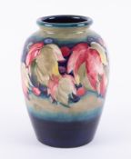 A William Moorcroft Flambe leaf and berries design vase, height 18cm.