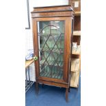 An Edwardian mahogany inlaid single door display cabinet, height 170cm.