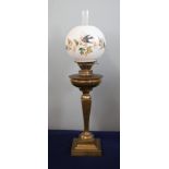 A Victorian oil lamp with white shade decorated with flowers, height excluding chimney 63cm.