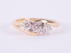 An 18ct yellow & white gold three stone twist design ring set with 0.50 carats (total weight) of