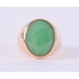 An 18ct yellow gold signet ring set with an oval cabochon cut jade, measuring approx. 16mm x 12.5mm,