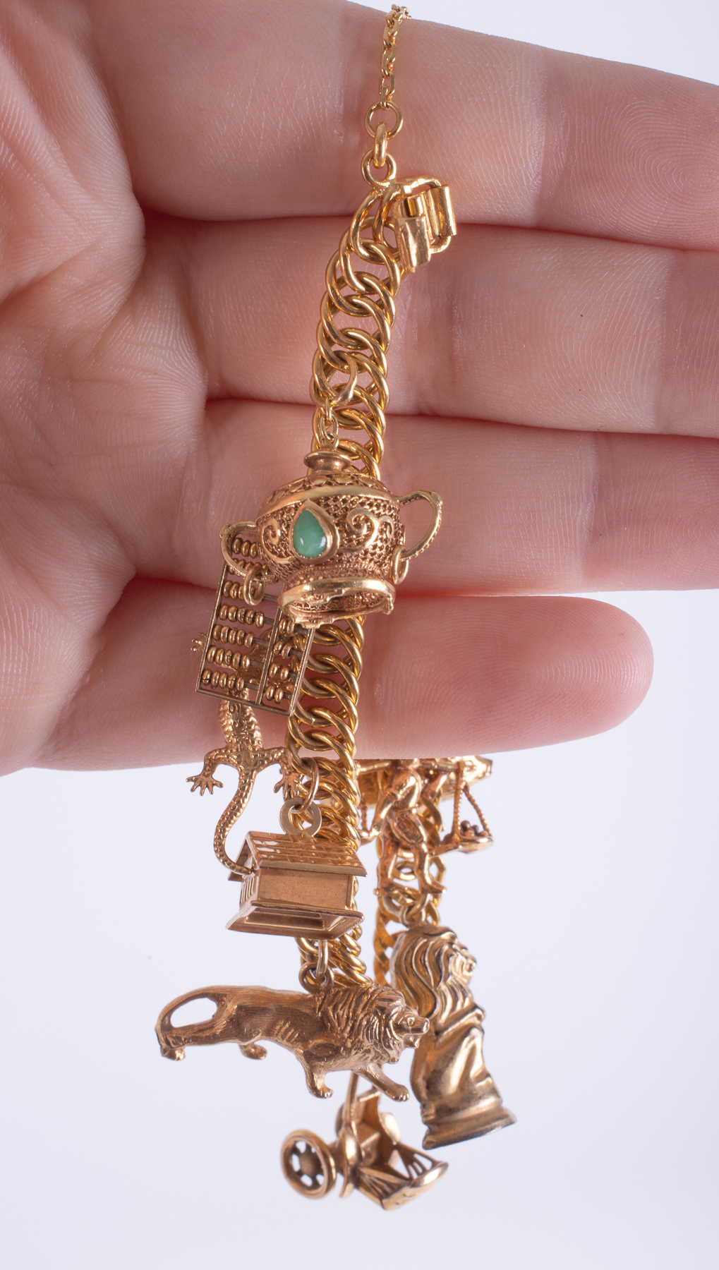 A high carat charm bracelet (indistinct marking but probably 14ct plus) with ten gold charms, five - Image 2 of 2