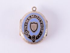 A double sided memorial locket with engraved floral pattern to one side and blue & black