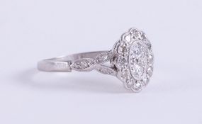 An Art Deco platinum ring set with round cut diamonds, approx. total diamond weight 0.20 carats, 2.