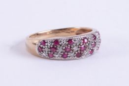 A 9ct yellow & white gold ring set with small round cut rubies and small round cut diamonds, 2.51gm,