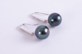 A pair of 18ct white gold drop earrings set with a 11.5mm black pearl & small round brilliant cut