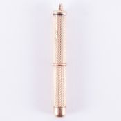 A 9ct yellow gold toothpick with an engineered finish, length 4.5cm (with pick retracted), 5.49gm.