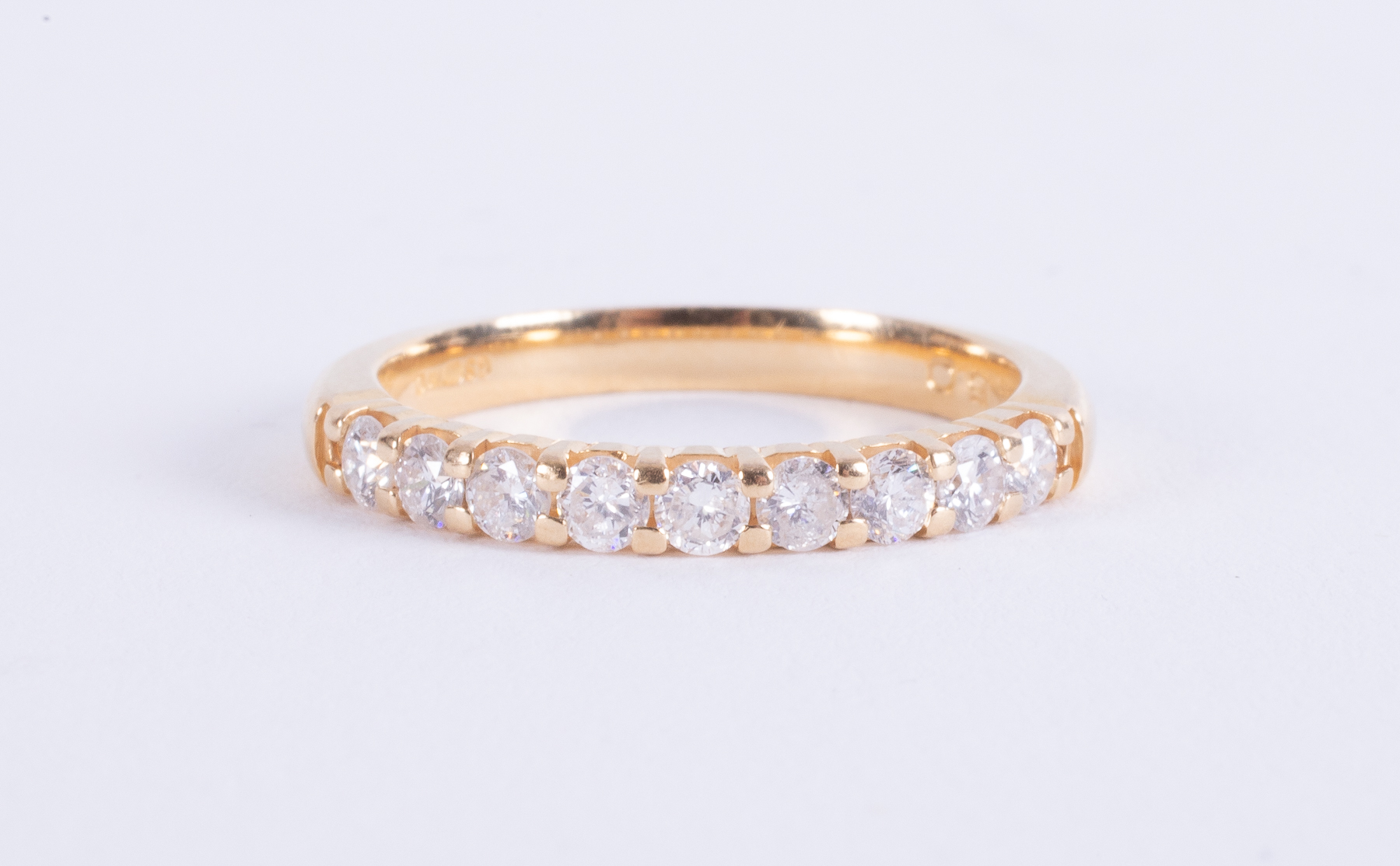 An 18ct yellow gold half eternity style ring set with round brilliant cut diamonds, total weight 0.