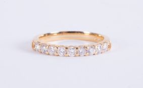 An 18ct yellow gold half eternity style ring set with round brilliant cut diamonds, total weight 0.