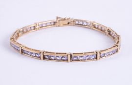 A 9ct yellow gold line bracelet set with round cut tanzanite's, approx. total tanzanite weight