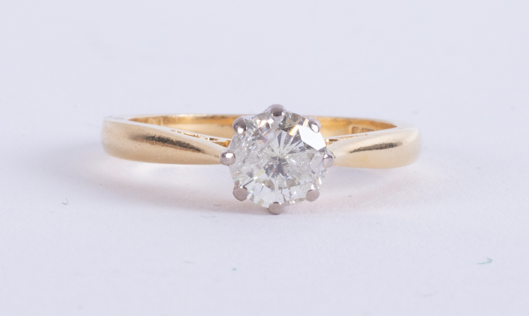 An 18ct yellow & white gold solitaire set with a round brilliant cut diamond, approx. 0.82 carats,