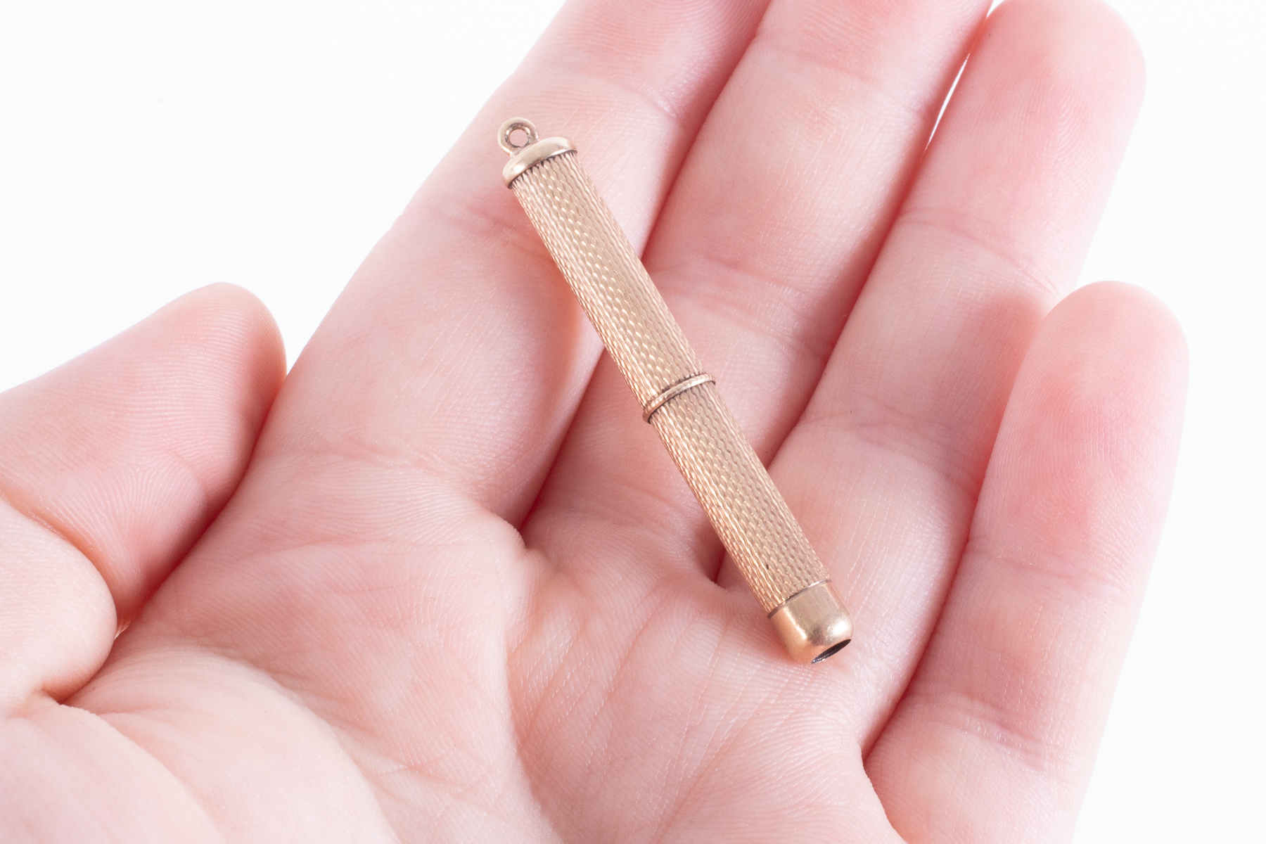 A 9ct yellow gold toothpick with an engineered finish, length 4.5cm (with pick retracted), 5.49gm. - Image 3 of 3