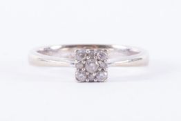 A 9ct white gold ring in a square design set with total weight 0.15 carats of round brilliant cut