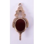 A 10ct yellow gold watch key, set with carnelian & agate fancy engraved scroll design pattern,