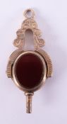 A 10ct yellow gold watch key, set with carnelian & agate fancy engraved scroll design pattern,