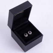 A pair of 9ct yellow & white gold cluster earrings set with a central oval dark blue sapphire and