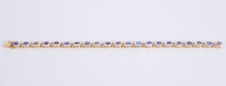 An 18ct yellow gold bracelet set with oval cabochon cut moonstones, measuring approx. 5.5mm x 4mm (