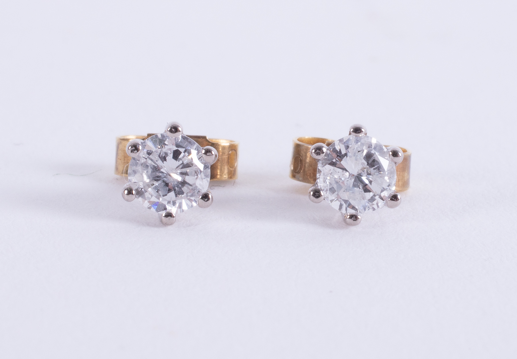 A pair of 18ct yellow & white gold studs set with round brilliant cut diamonds, total diamond weight