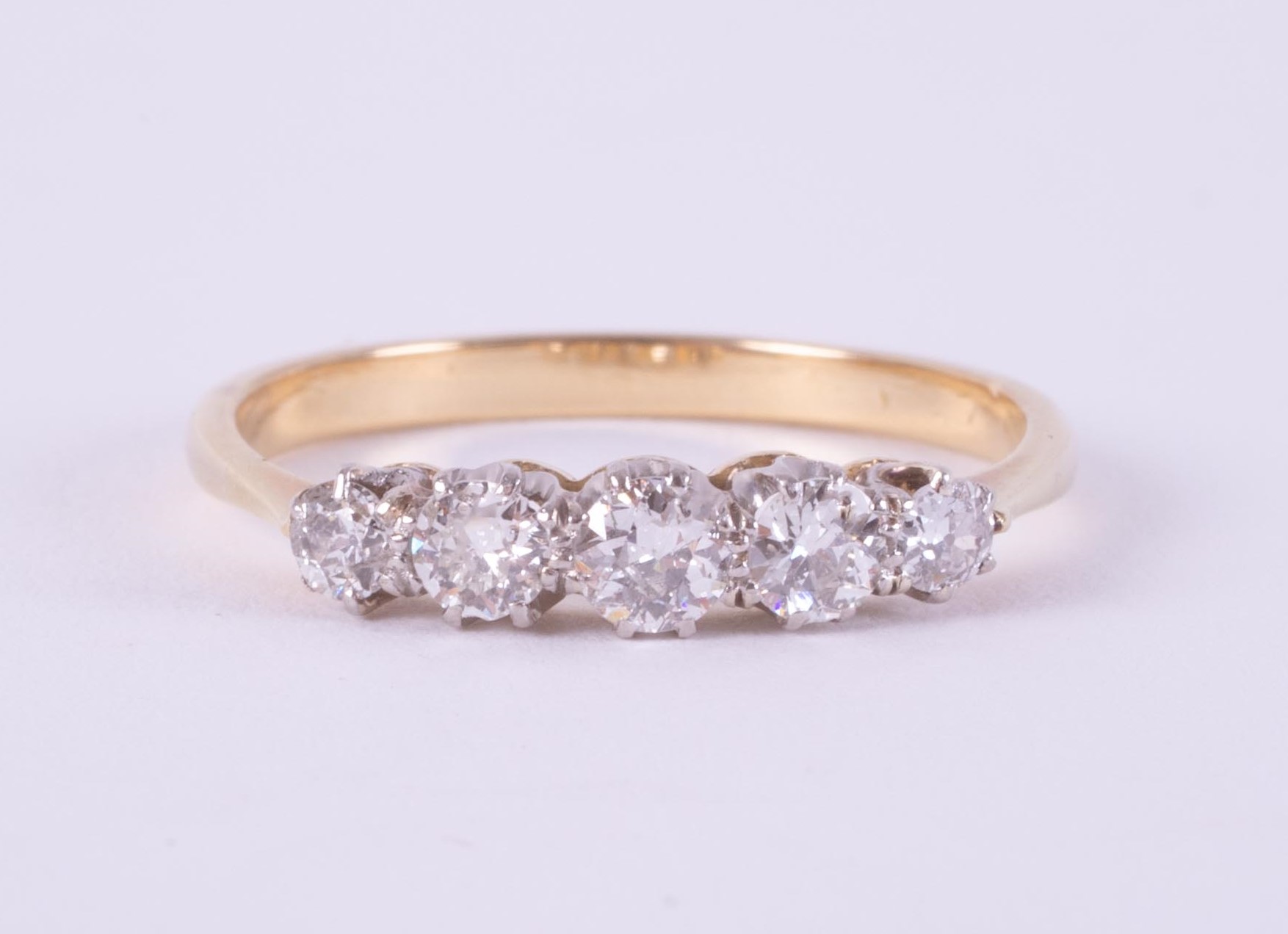 An 18ct yellow gold & platinum (no hallmarks & not tested) five stone ring set with old round